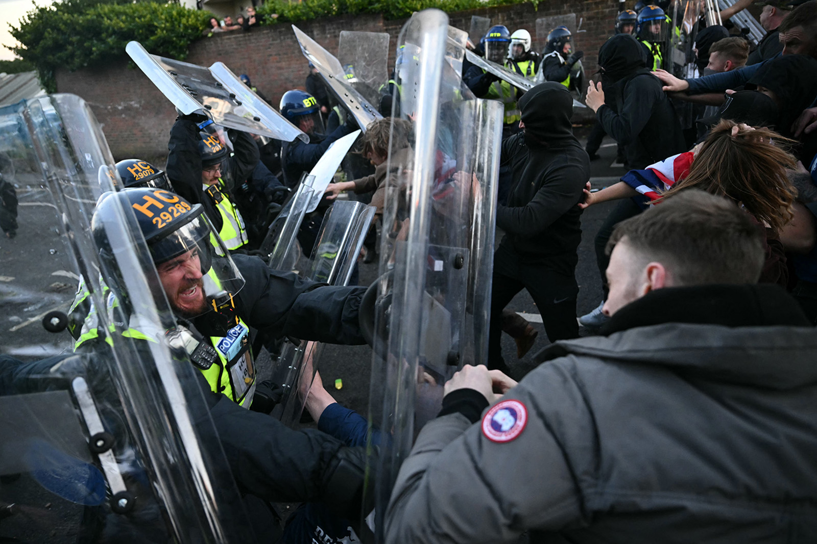 A photograph of rioters clashing with police officers, who are wearning helmets and protecting themselves with riot shields, in Portswood, Southampton, on Tuesday 2 June