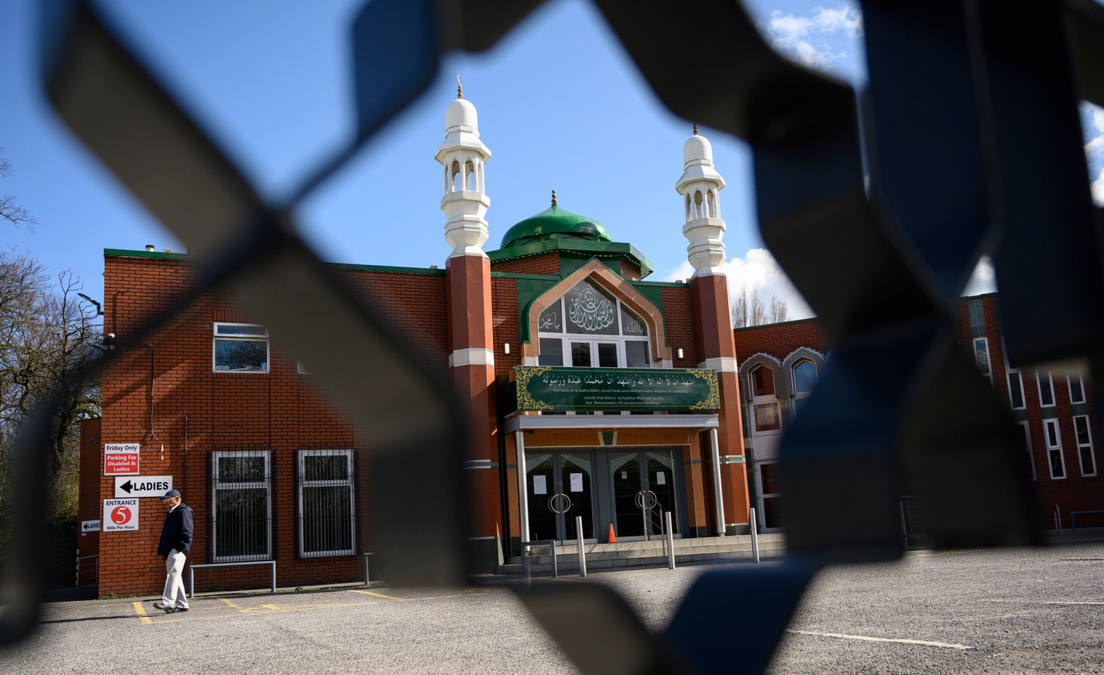 A photograph of Manchester Central Mosque, taken through a fence 