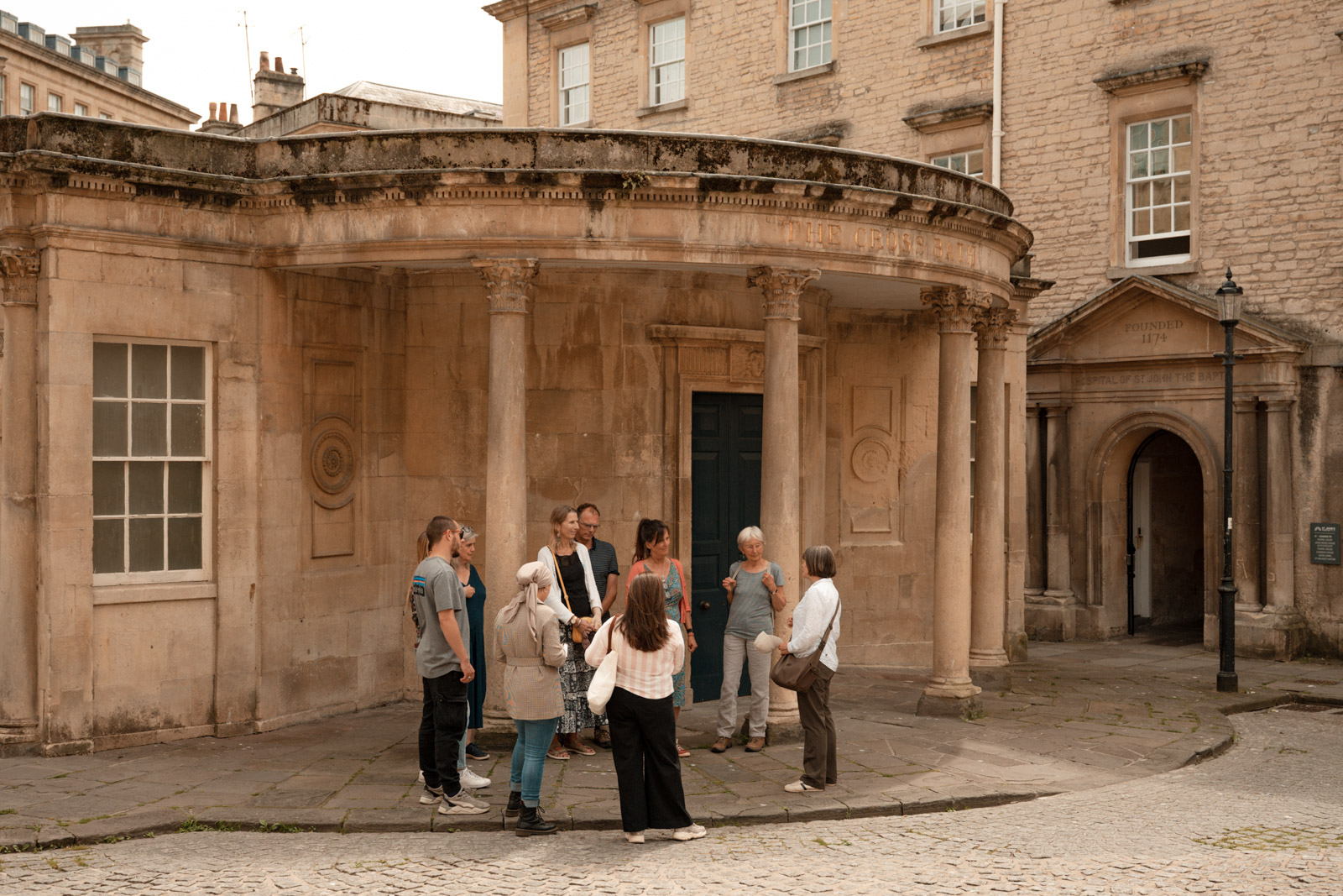 A photograph of the walking tour group outside the Cross Bath, a bathing house frequented by Ethiopian monarch Haile Selassie during his 1930s exile in the UK