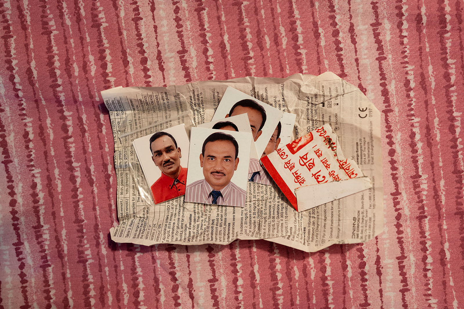 An image showing a selection of Gias Uddin's passport photos for his Italian visa application