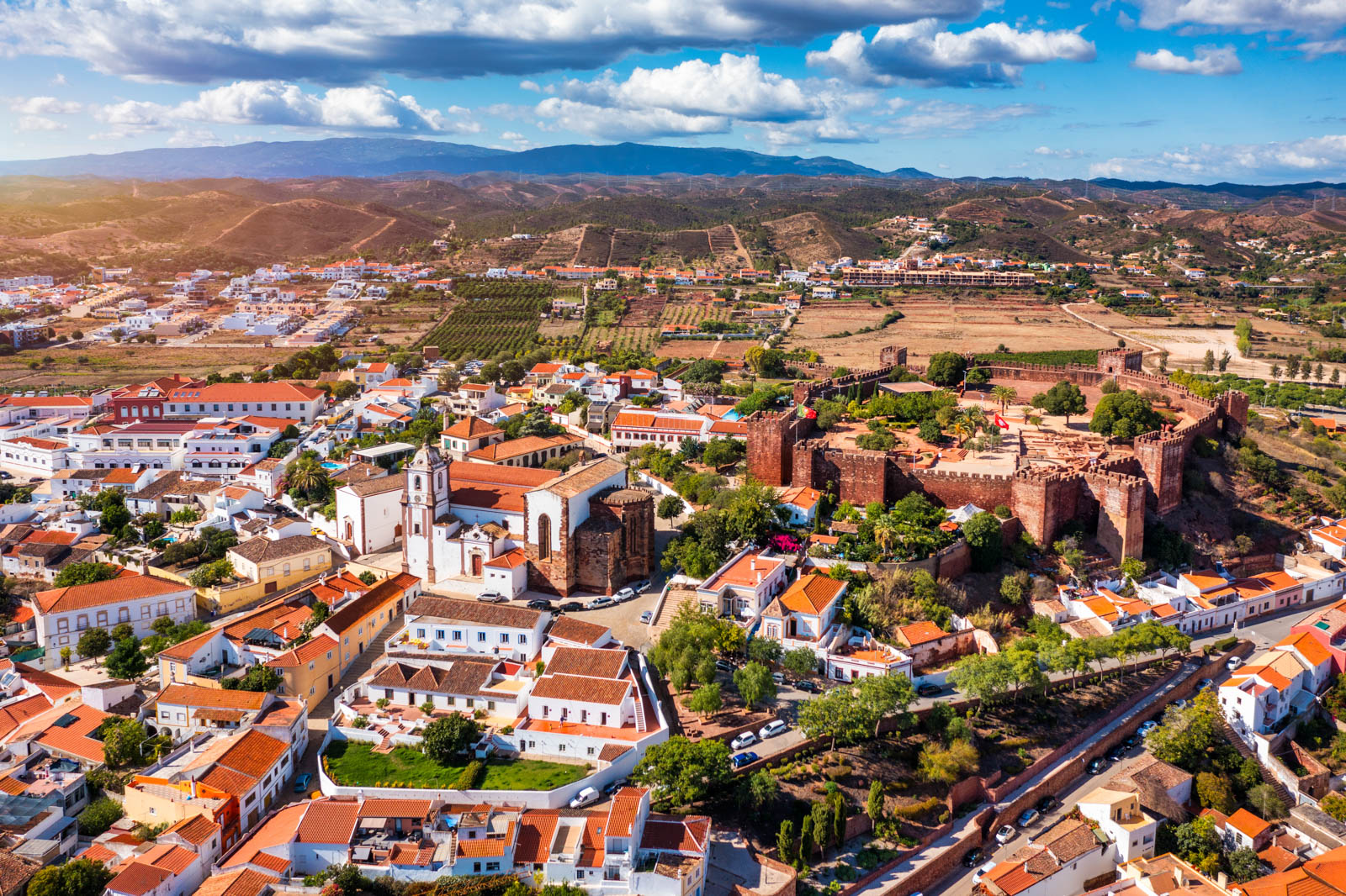 View of Silves town buildings with famous castle and cathedral, Algarve region, Portugal. Walls of medieval castle in Silves town, Algarve region, Portugal.