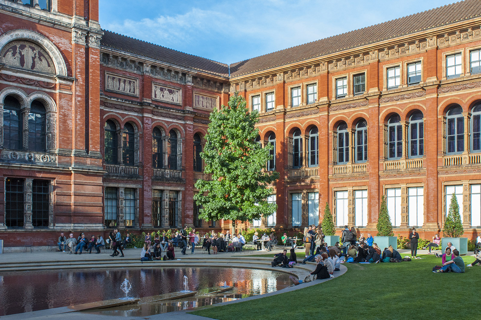 A photograph of people relaxing in the John Madejski Garden at the Victoria and Albert Museum, which hosts more than 19,000 Islamic artefacts, including the world's oldest dated carpet