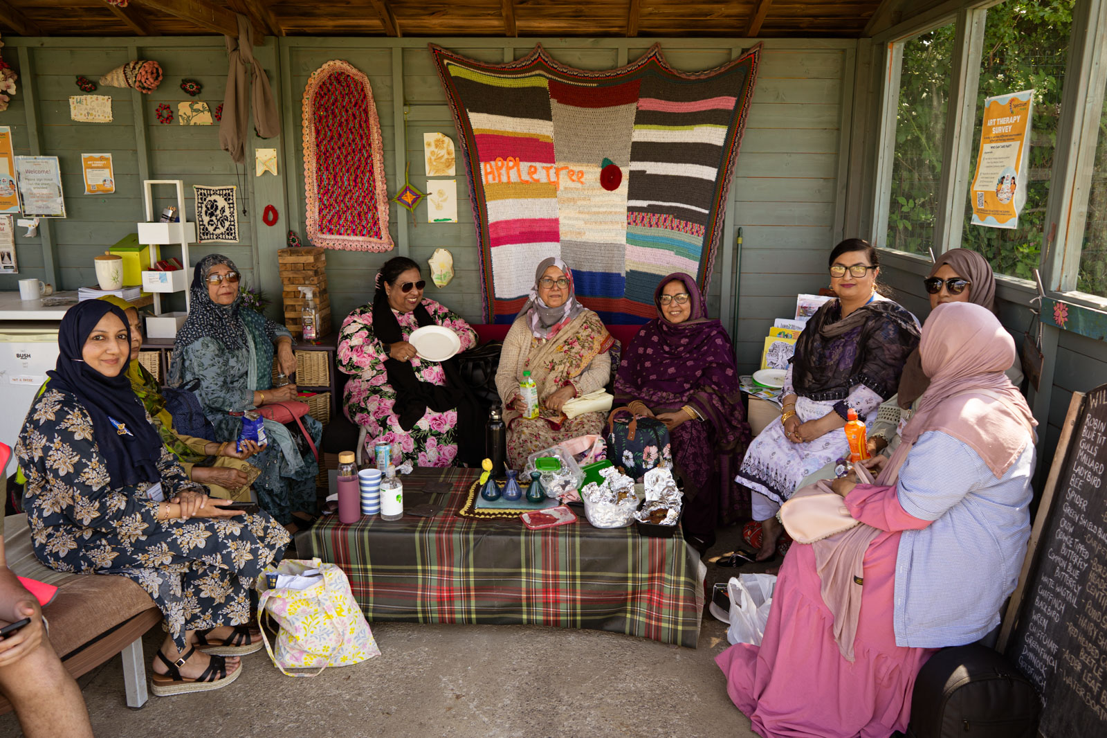 A photograph of the women's group meeting in a shed at Appletree Community Garden