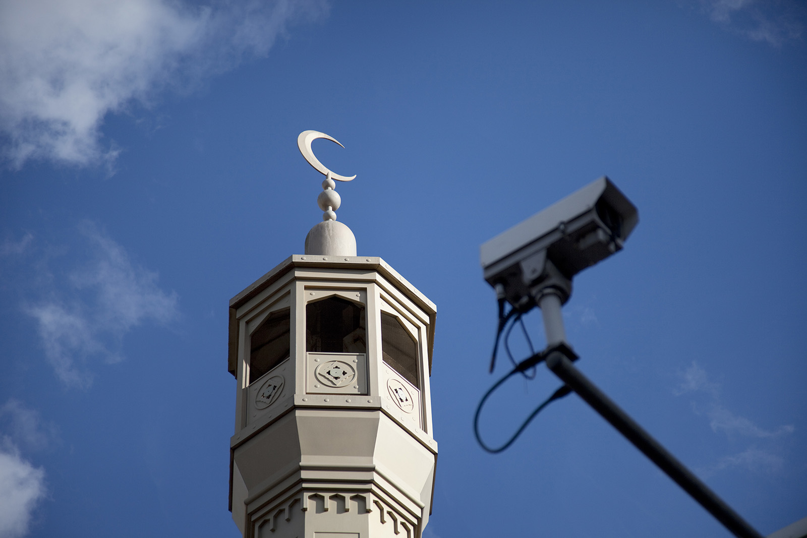A photograph of a CCTV camera below the minaret of the East London Mosque