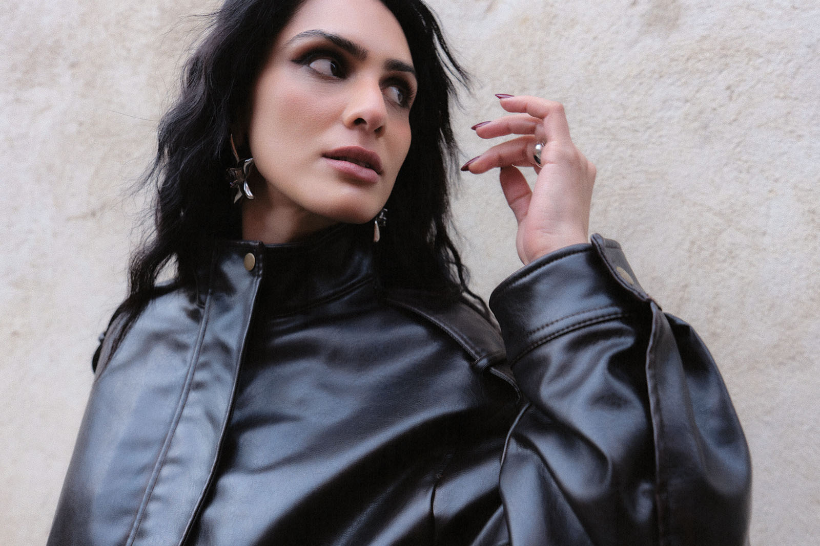 A publicity portrait photograph of New York dance music artist ZAINAB, wearing a leather jacket