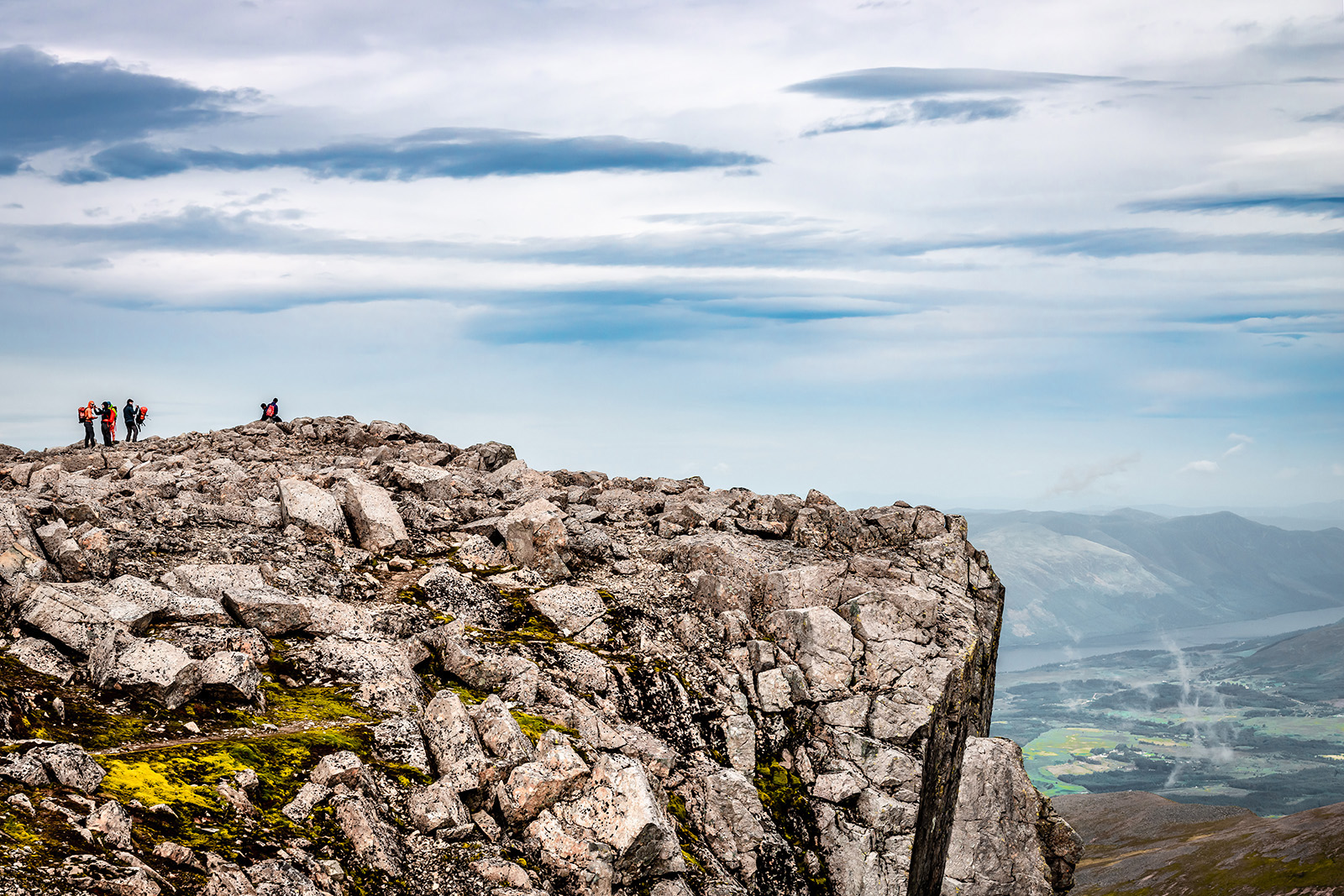 A stock photograph of the rocky summit of Ben Nevis, at 4,413ft the highest mountain in the UK, with Loch Eil visible in the background