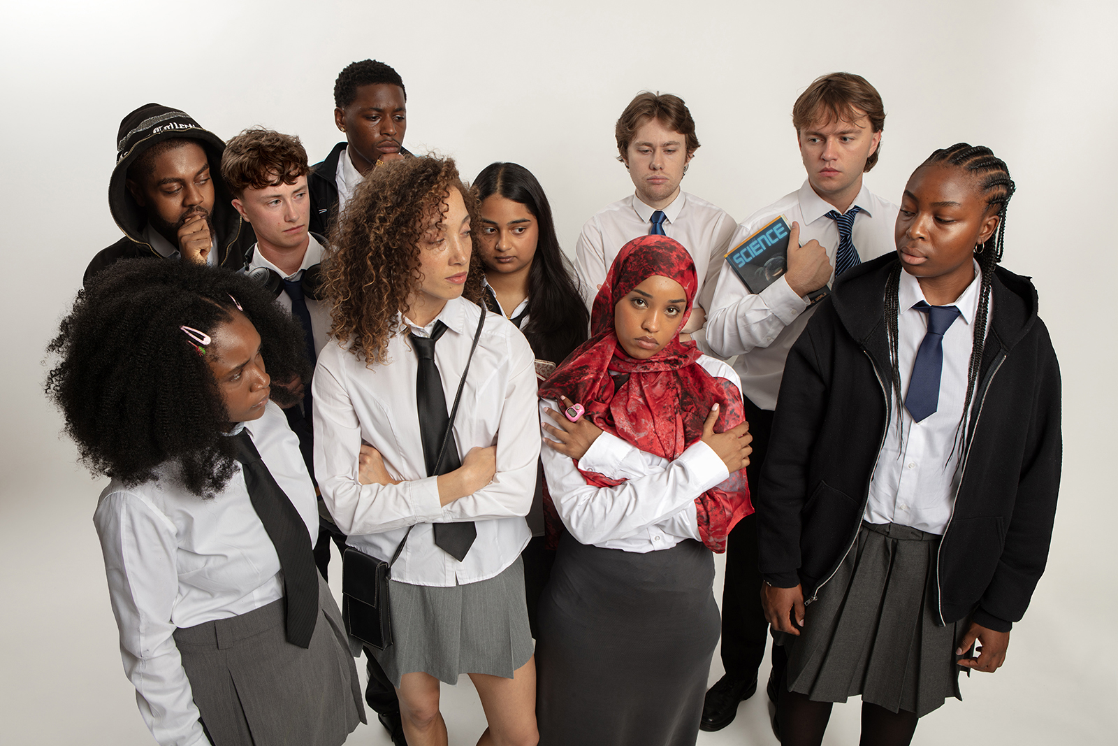 A promotional photograph for Anders Lustgarten's Extremism, featuring a group of young actors dressed as school children