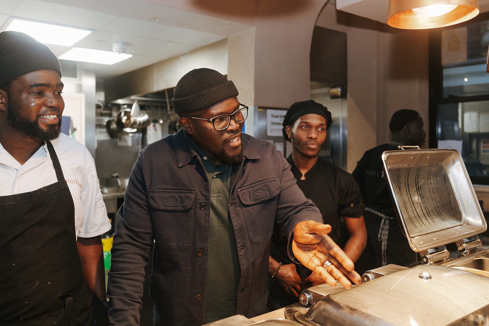 A photograph of Little Baobab owner Khadim Mané speaking to a group of chefs in the restaurant's now closed kitchen in the Africa Centre in May 2026
