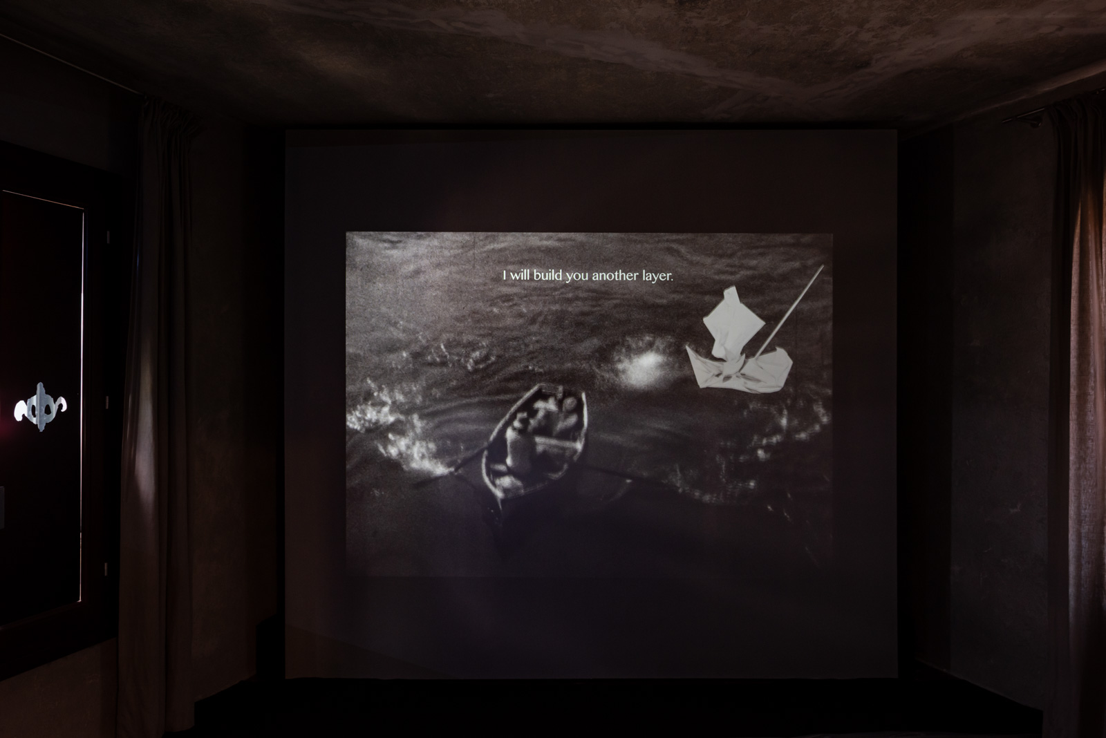 A photograph of a large screen in the Somalia Pavilion at the Venice Biennale, showing Asmaa Jama's short film The Blood Coast