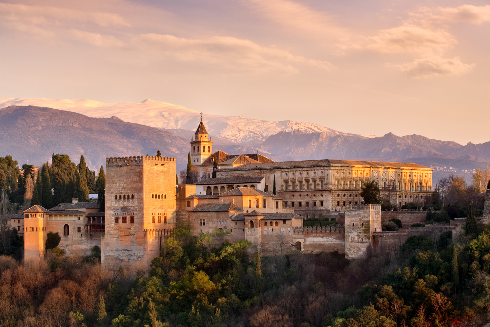 A photograph of the Alhambra, Granada, southern Spain, with snow-capped mountains in the background