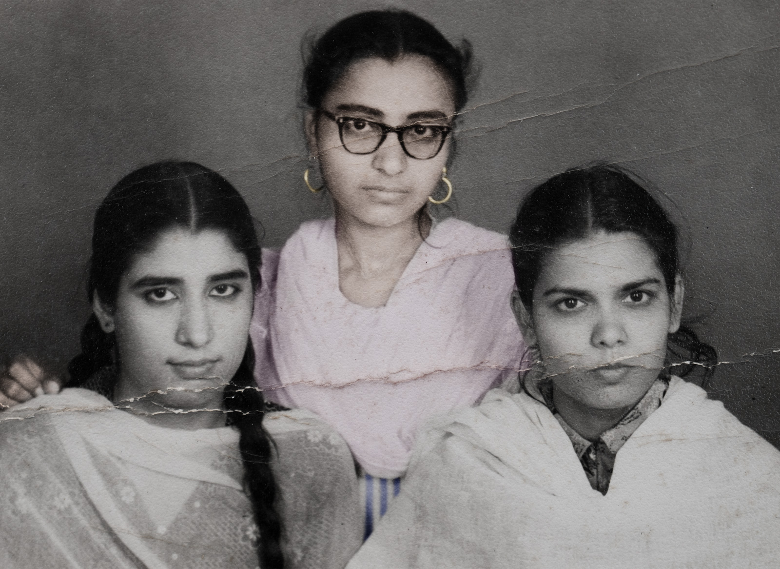 A black and white Malik family archive photograph from Aman Alam's series Ozymandias, documenting his grandmother's life with Alzheimer's, showing her as a child, with two other children