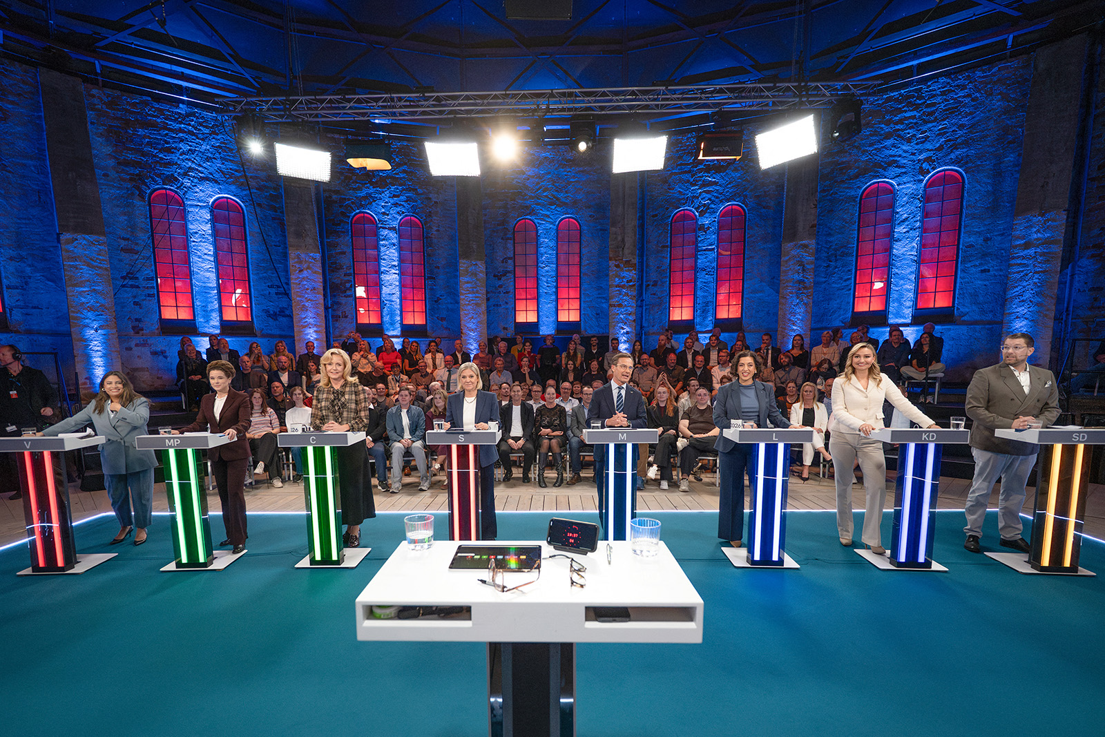 A photograph of eight party leaders standing at their lecterns in the studio, with the audience behind them, during the final televised debate on 11 September ahead of Sweden's 2026 general election