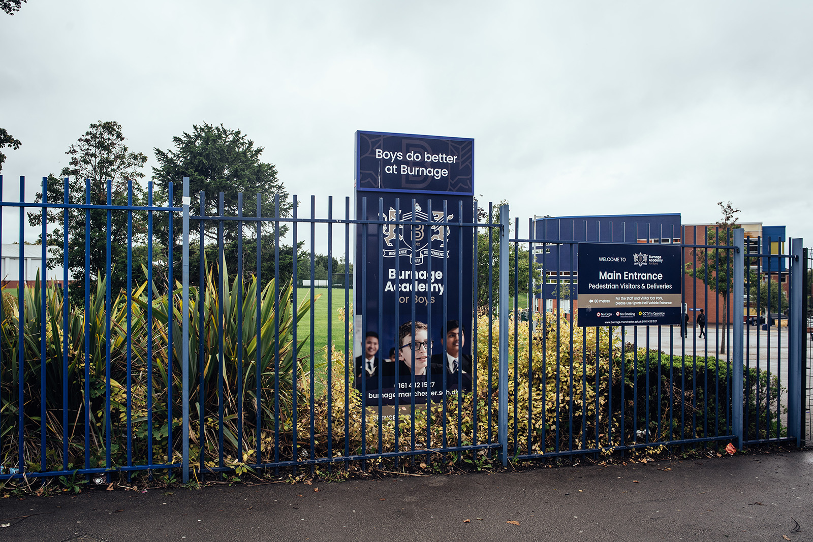 The entrance to Burnage Academy for Boys, formerly Burnage High School, where 13-year-old Ahmed Iqbal Ullah was killed in a racist attack in 1986, in Burnage on Wednesday, 2 September 2026. Photo by KC Nwakalor for Hyphen.