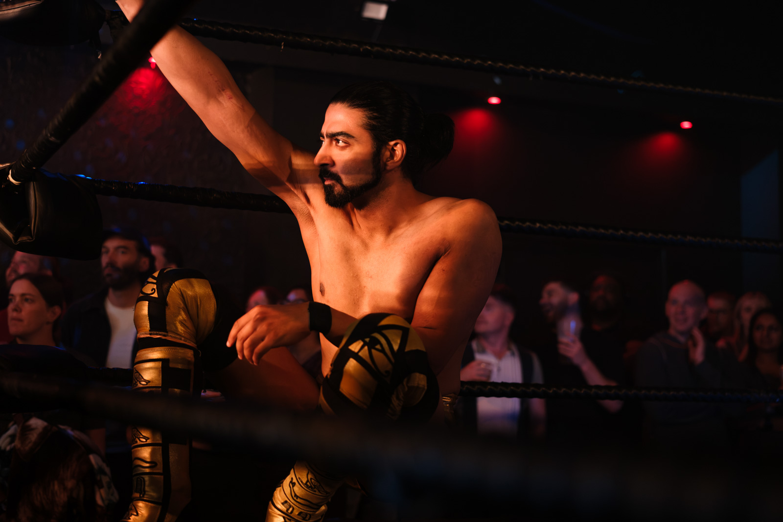 A photograph of Marduk Malik hanging off the ropes during a bout, waiting to return to the action in the ring