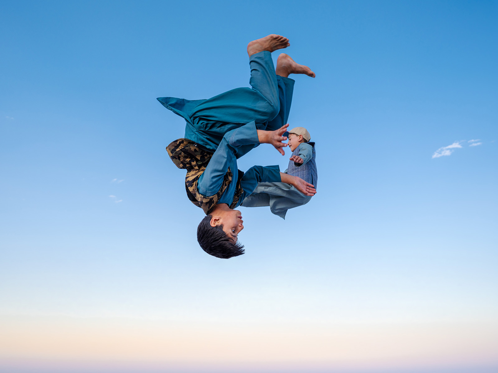 A photograph of from Daniel Malikyar's new photobook Afghanistan
of two trampolining boys captured in mid air, one upside down, with the ground below not in the frame so that they appear to be floating in the sky